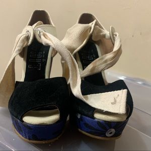 Wedge blue Black and Tan sandals .